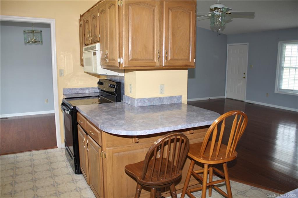 1095 Lawrence Road Clover, SC 29710 - Photo 8 of 20 a kitchen with a sink a table and chairs