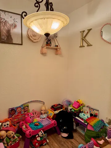 a bedroom with a bed and a chandelier