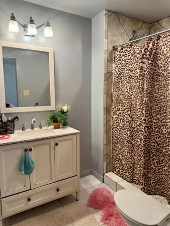 a bathroom with a sink toilet and shower