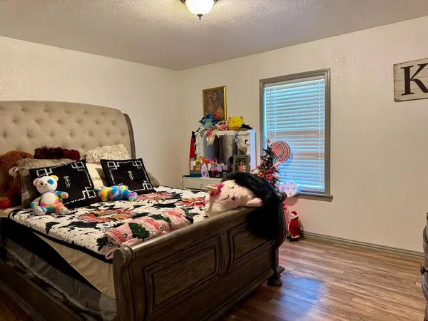 a bed room with bed and a window