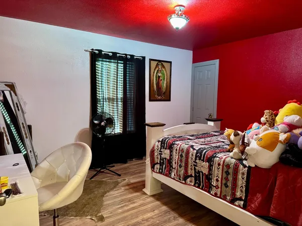 a bedroom with a bed and window