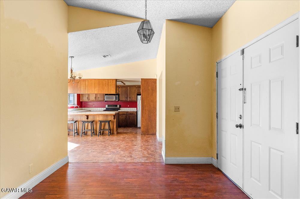 114 Chaparrel Street Tehachapi, CA 93561 - Photo 8 of 31 a view of a kitchen from the hallway