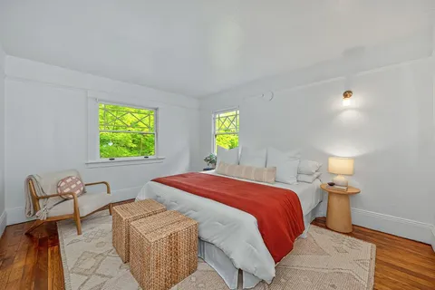 a bedroom with a bed and a lamp on table