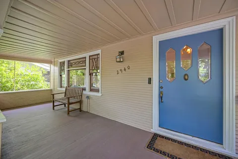 a spacious bedroom with a bed and wooden floor