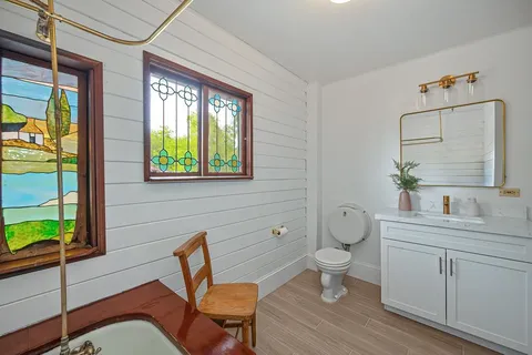 a backyard of a house with table and chairs