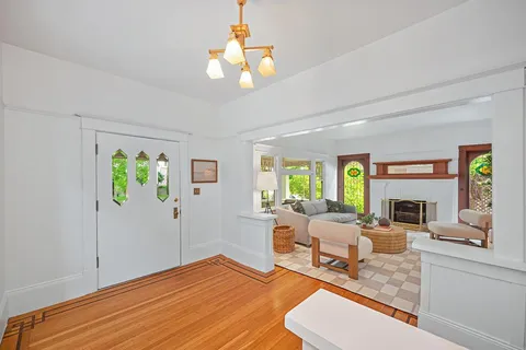a living room with furniture and a chandelier