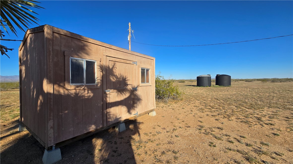 21688 South Roy Rogers Road Yucca, AZ 86438 - Photo 1 of 36 a front view of a house with a yard