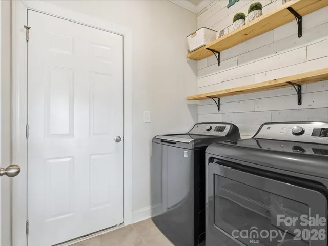 a view of a storage and utility room with washer and dryer