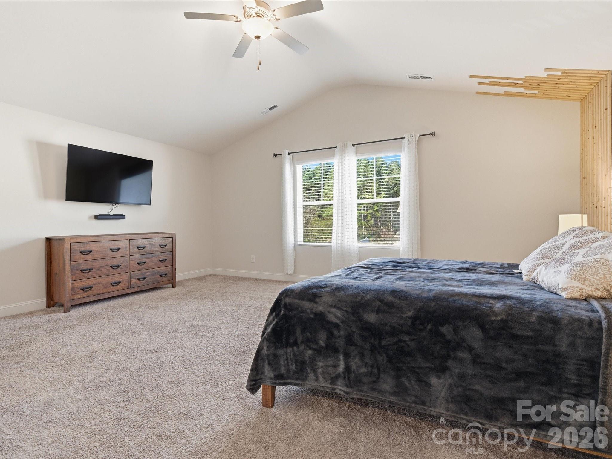 4435 Allenby Place Monroe, NC 28110 - Photo 16 of 32 a bedroom with a bed and a flat screen tv