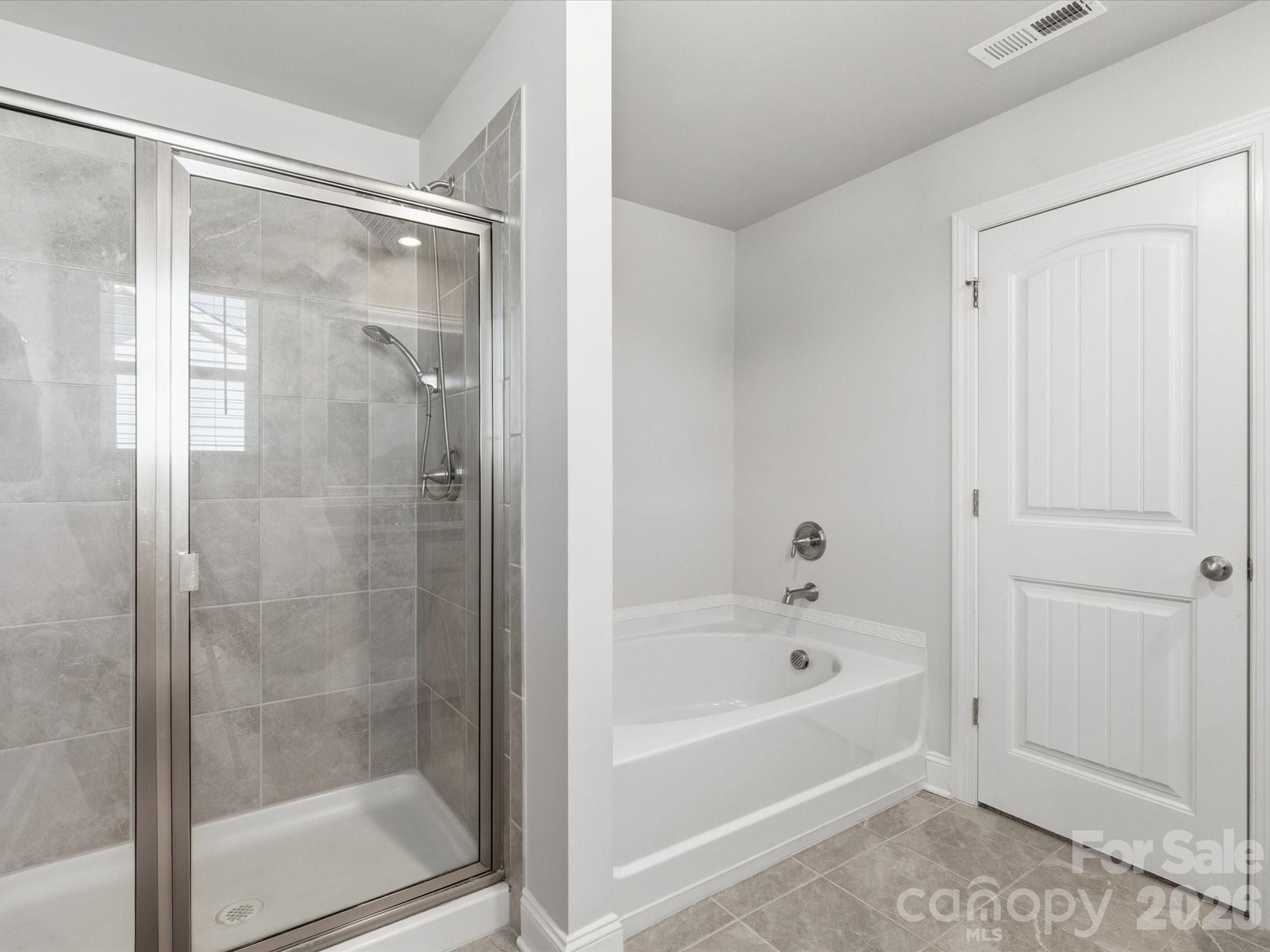 4435 Allenby Place Monroe, NC 28110 - Photo 17 of 32 a bathroom with a bathtub and a shower