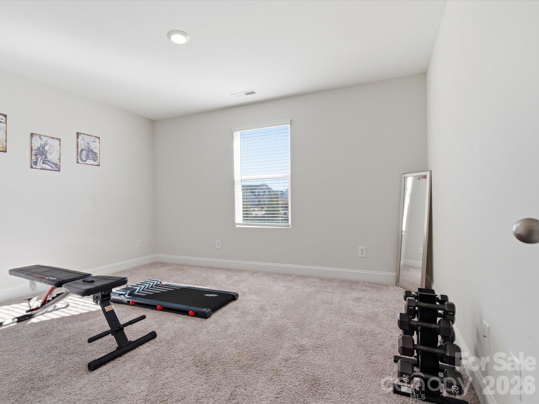 4435 Allenby Place Monroe, NC 28110 - Photo 21 of 32 a view of a room with a window and gym equipment