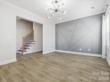 a view of an empty room with window and a ceiling fan