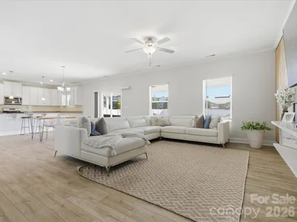 a living room with furniture and a chandelier