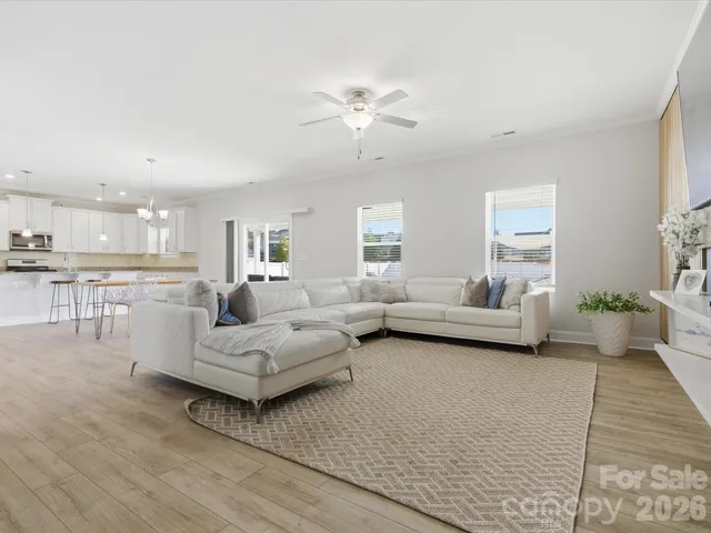 a living room with furniture and a chandelier