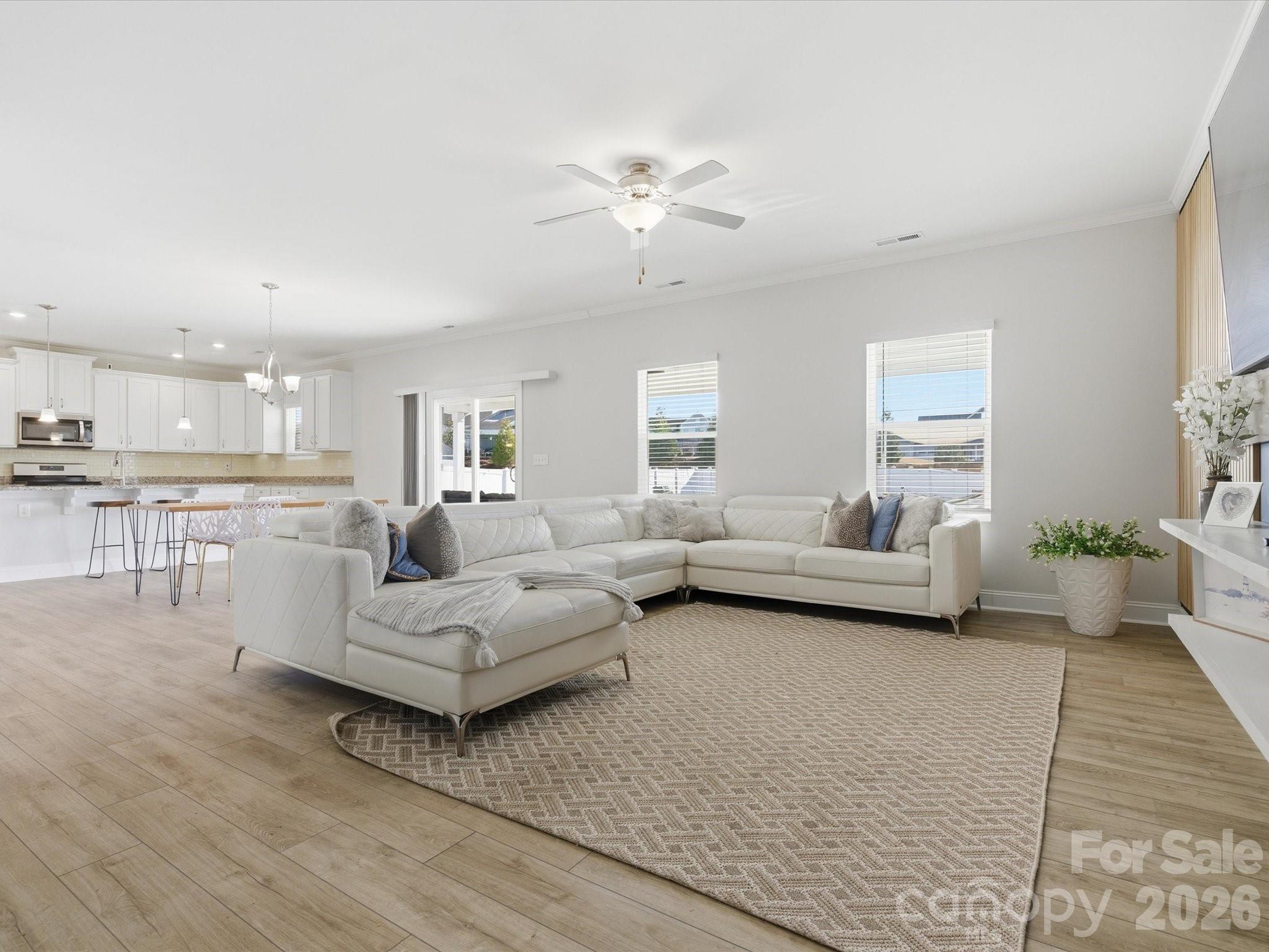 4435 Allenby Place Monroe, NC 28110 - Photo 6 of 32 a living room with furniture and a chandelier