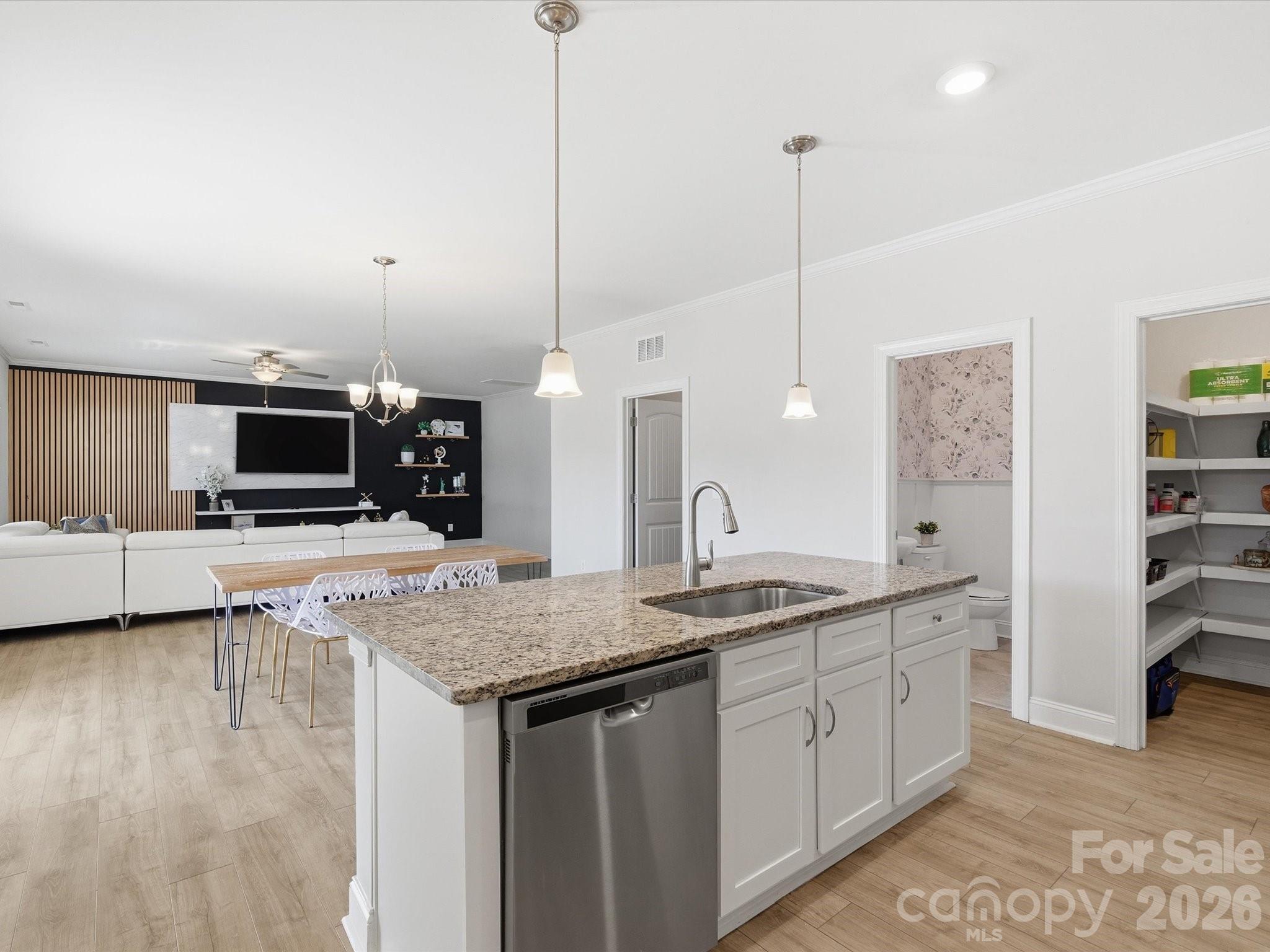 4435 Allenby Place Monroe, NC 28110 - Photo 7 of 32 a kitchen with stainless steel appliances granite countertop a sink a stove and a wooden floor