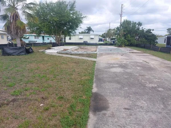 a view of a yard with cars