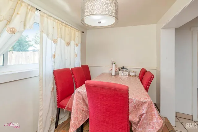 a dining room with furniture and wooden floor