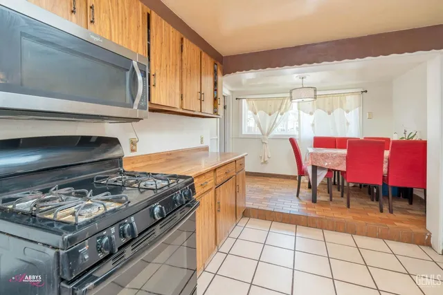 a kitchen with a stove a sink and a microwave