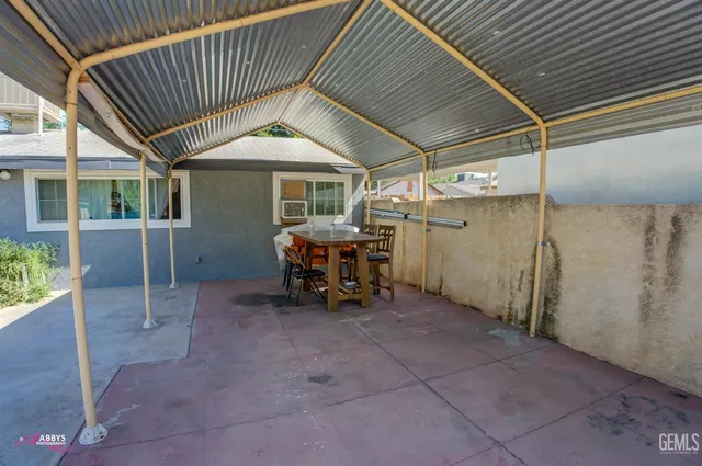a view of a chairs and table in the patio