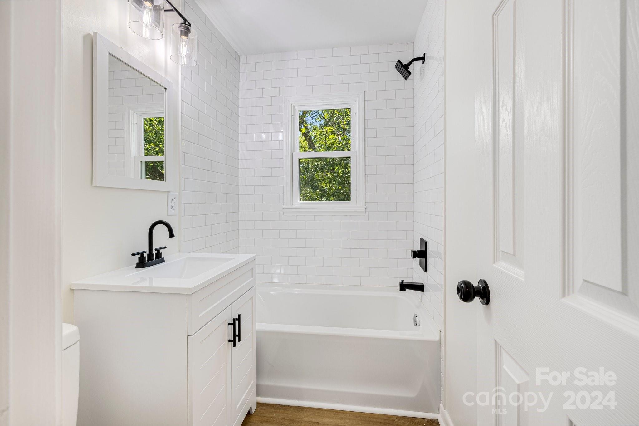 815 Poors Ford Road Rutherfordton, NC 28139 - Photo 19 of 30 a bathroom with a bathtub a sink and a window