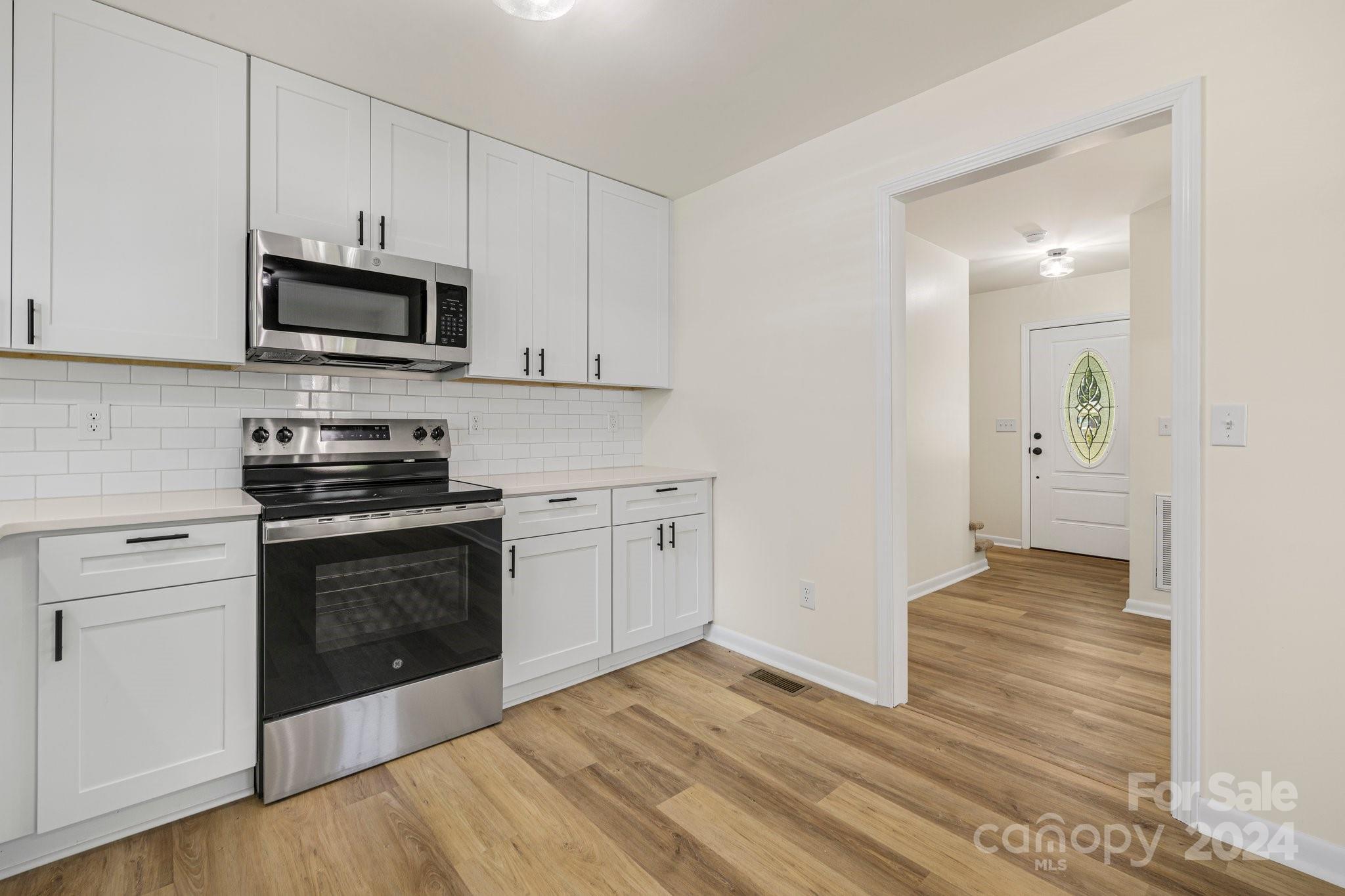 815 Poors Ford Road Rutherfordton, NC 28139 - Photo 10 of 30 a kitchen with stainless steel appliances granite countertop a stove a microwave and a hard wood floors