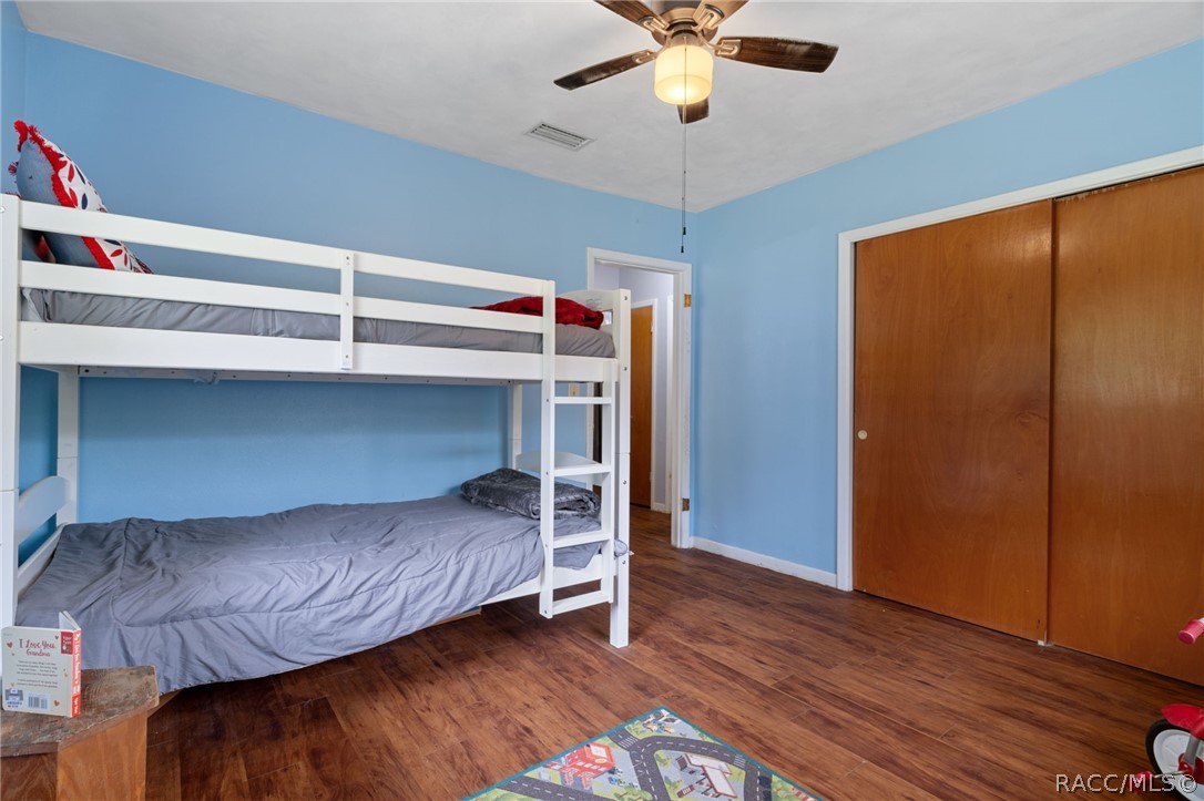 3355 South Highlands Avenue Inverness, FL 34452 - Photo 23 of 30 a bedroom with a bed and wooden floor