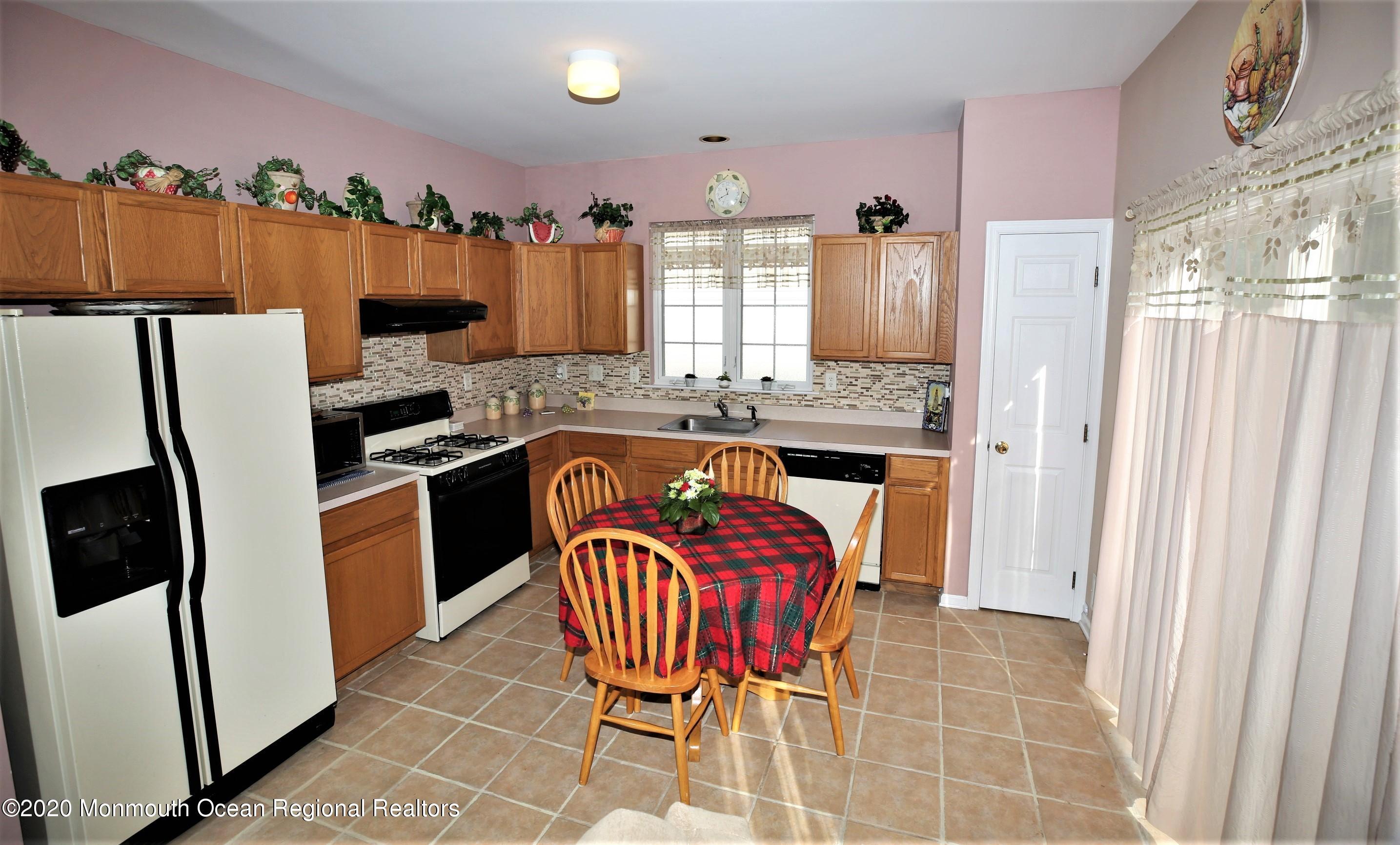 25 Byron Road Brick, NJ 08724 - Photo 16 of 35 a kitchen with stainless steel appliances a refrigerator a stove a sink dishwasher and wooden cabinets