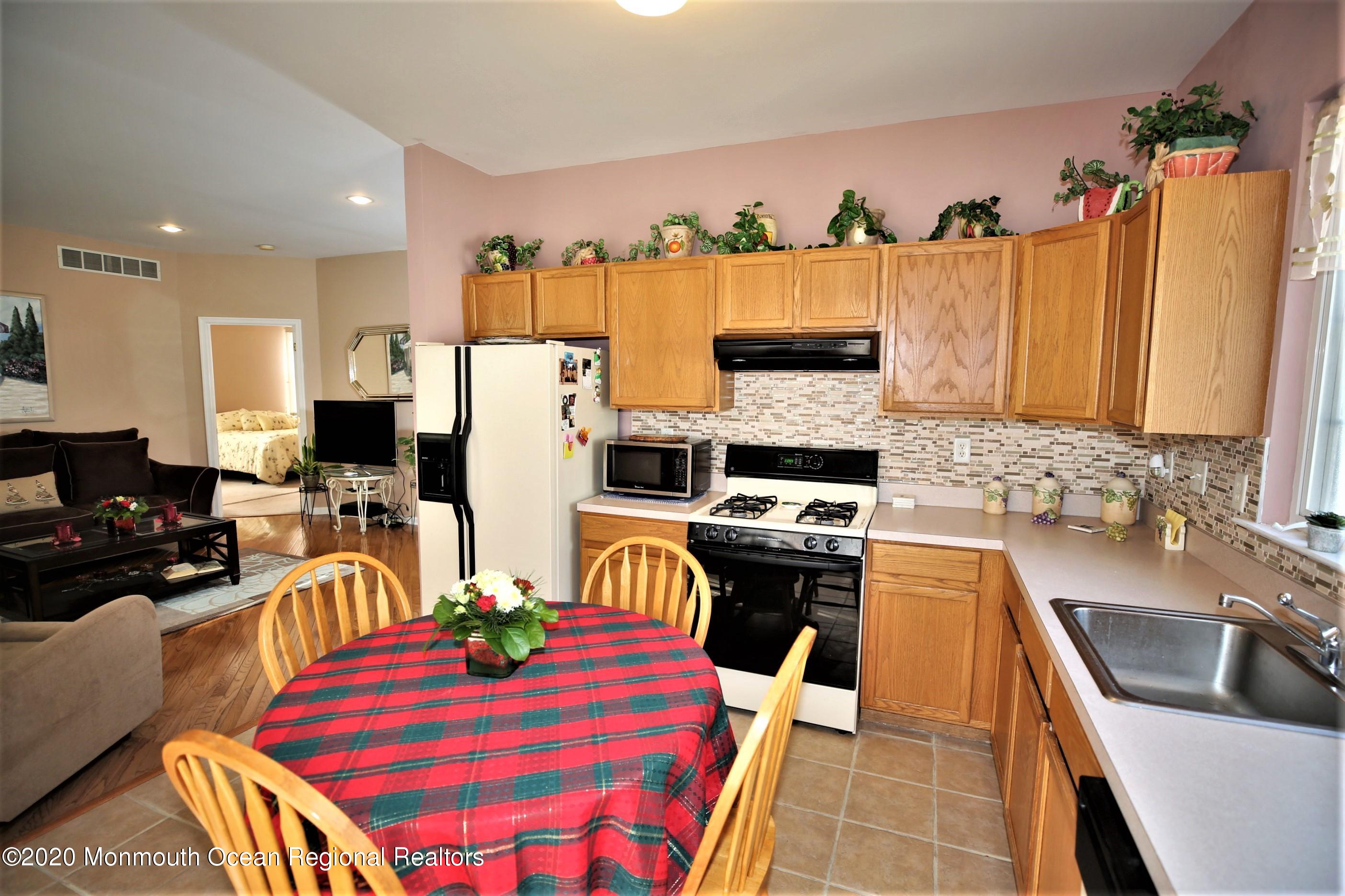 25 Byron Road Brick, NJ 08724 - Photo 17 of 35 a kitchen with stainless steel appliances granite countertop a refrigerator a stove top oven a sink dishwasher and white cabinets