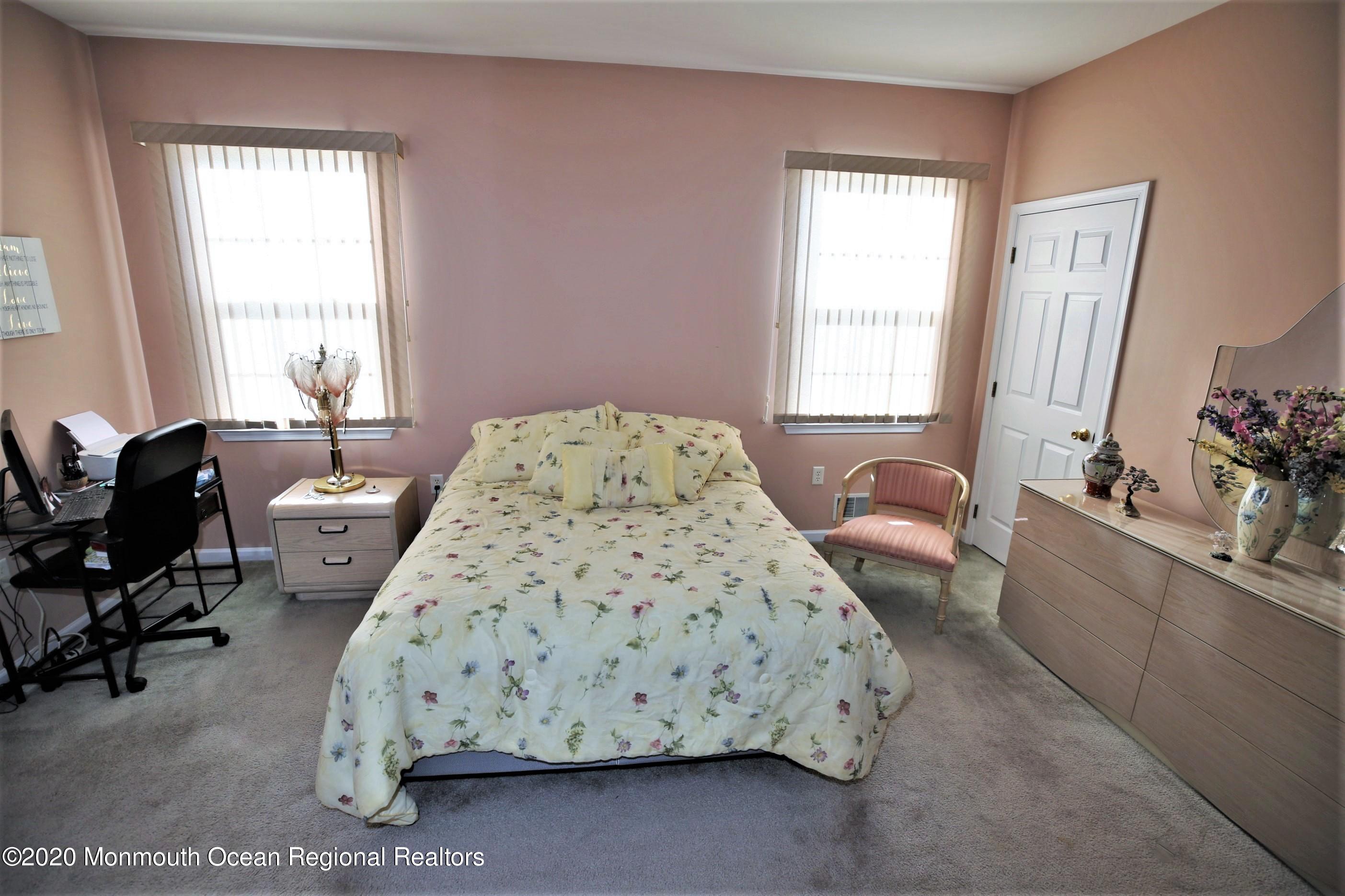 25 Byron Road Brick, NJ 08724 - Photo 21 of 35 a spacious bedroom with a bed couch and a window