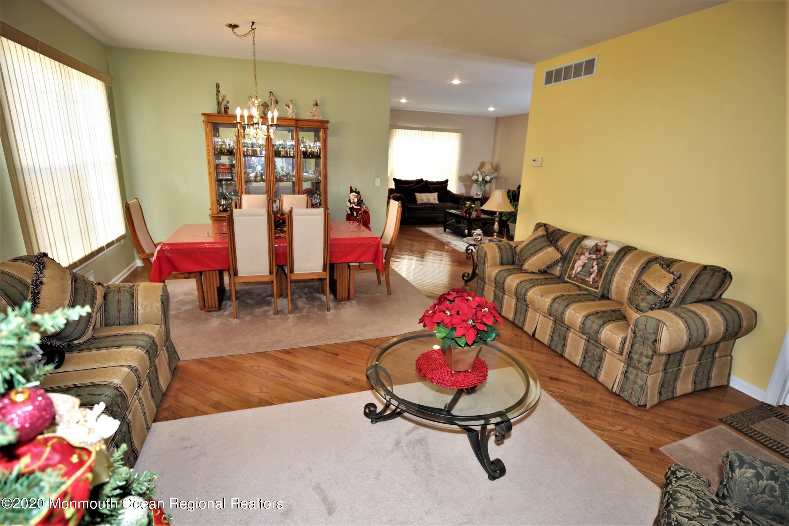 25 Byron Road Brick, NJ 08724 - Photo 9 of 35 a living room with furniture and a chandelier