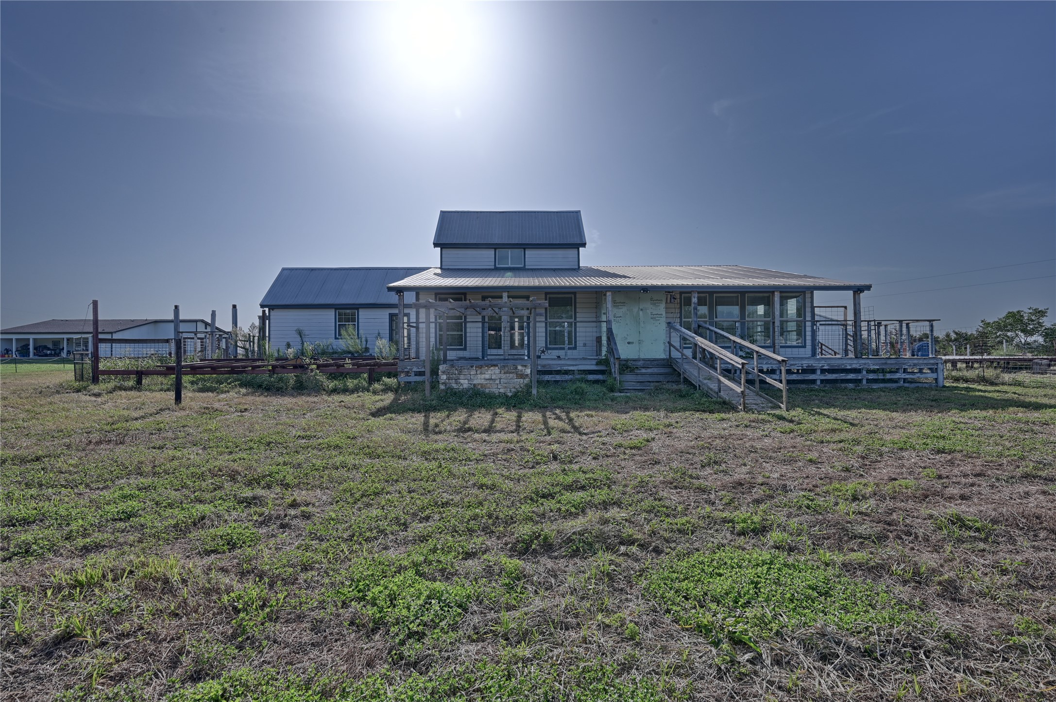 2980 Rabbs Prairie Road La Grange, TX 78945 - Photo 19 of 28 A charming farmhouse with a sprawling porch and accessible ramp offers rustic tranquility.