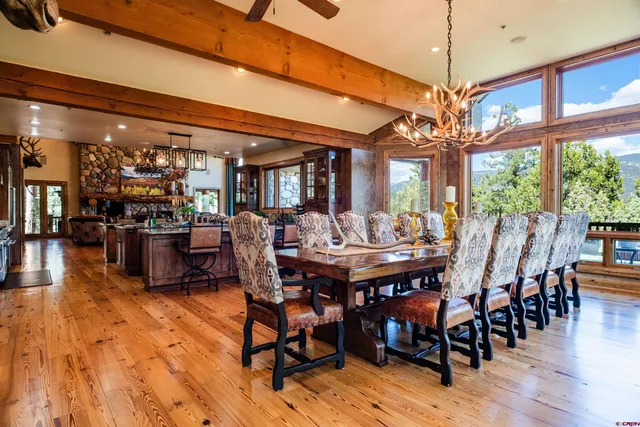 a view of a dining room with furniture wooden floor and chandelier