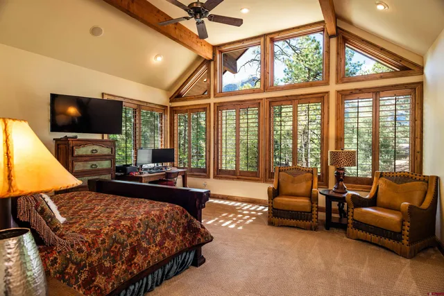 a bedroom with furniture and a flat screen tv