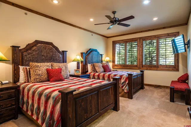 a bed room with two bed and a large window