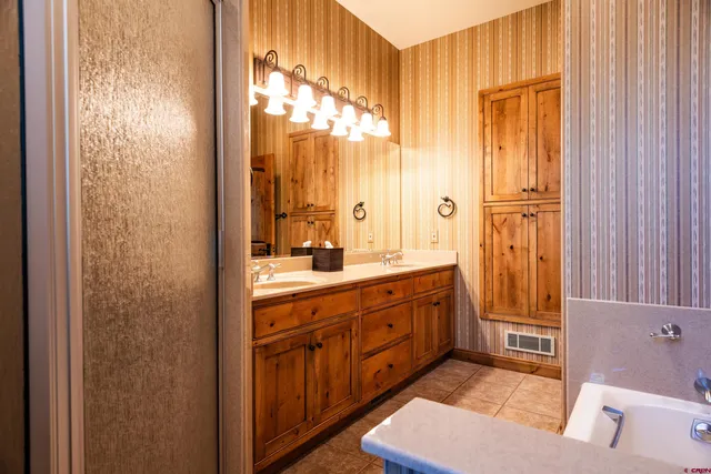 a spacious bathroom with a mirror and a shower