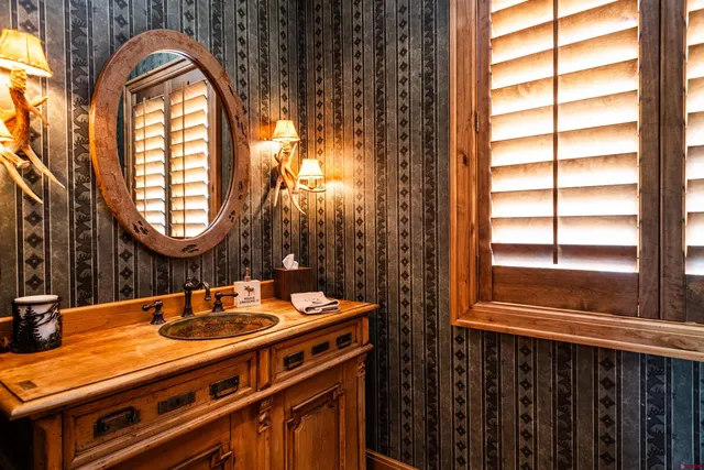 a bathroom with a sink a mirror and a window