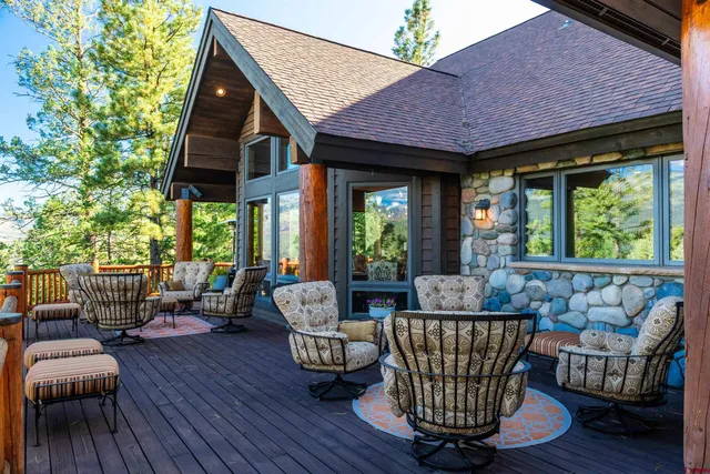 a balcony with furniture and wooden floor
