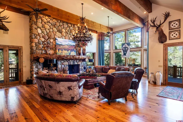 a living room with furniture a fireplace and a large window