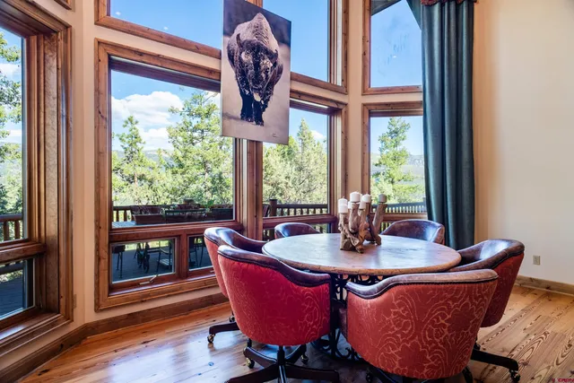 a view of a dining room with furniture wooden floor and a window