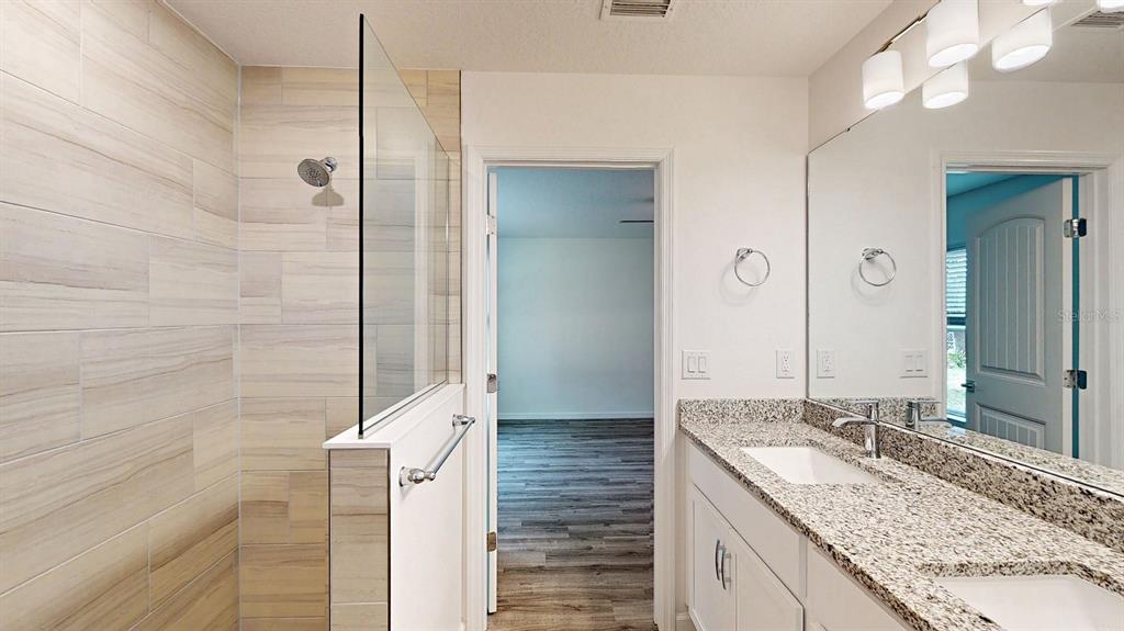 2816 Trico Road North Port, FL 34287 - Photo 5 of 11 a bathroom with a granite countertop sink and a mirror