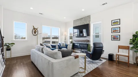 a living room with fireplace furniture and a flat screen tv