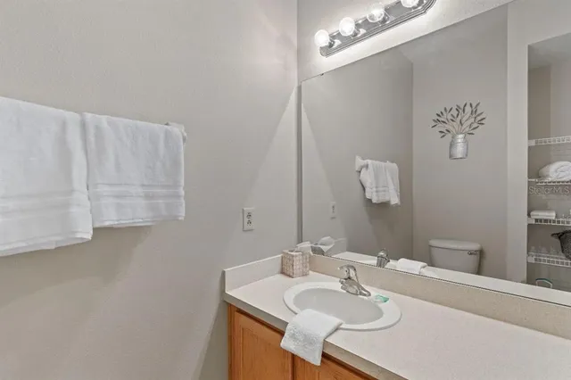 a bathroom with a sink vanity and a mirror