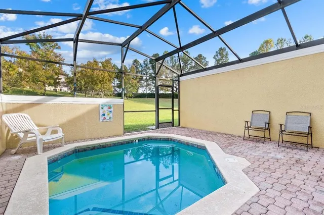 a view of a swimming pool with a patio