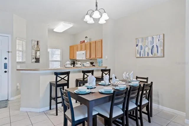 a view of a dining room with furniture and chandelier