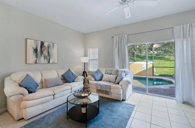a living room with furniture and a large window