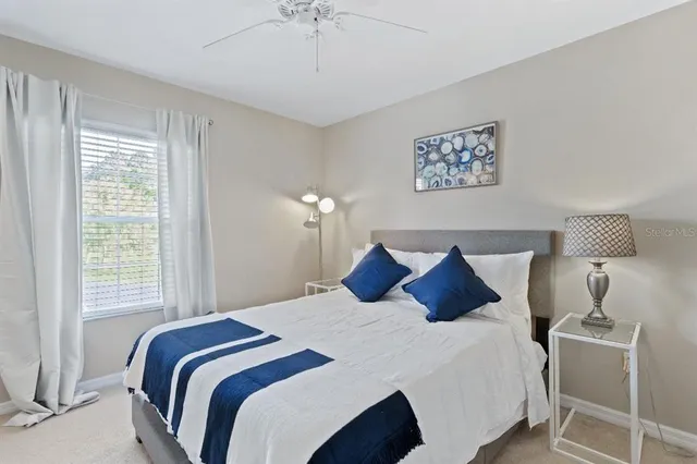 a bedroom with a bed and a lamp