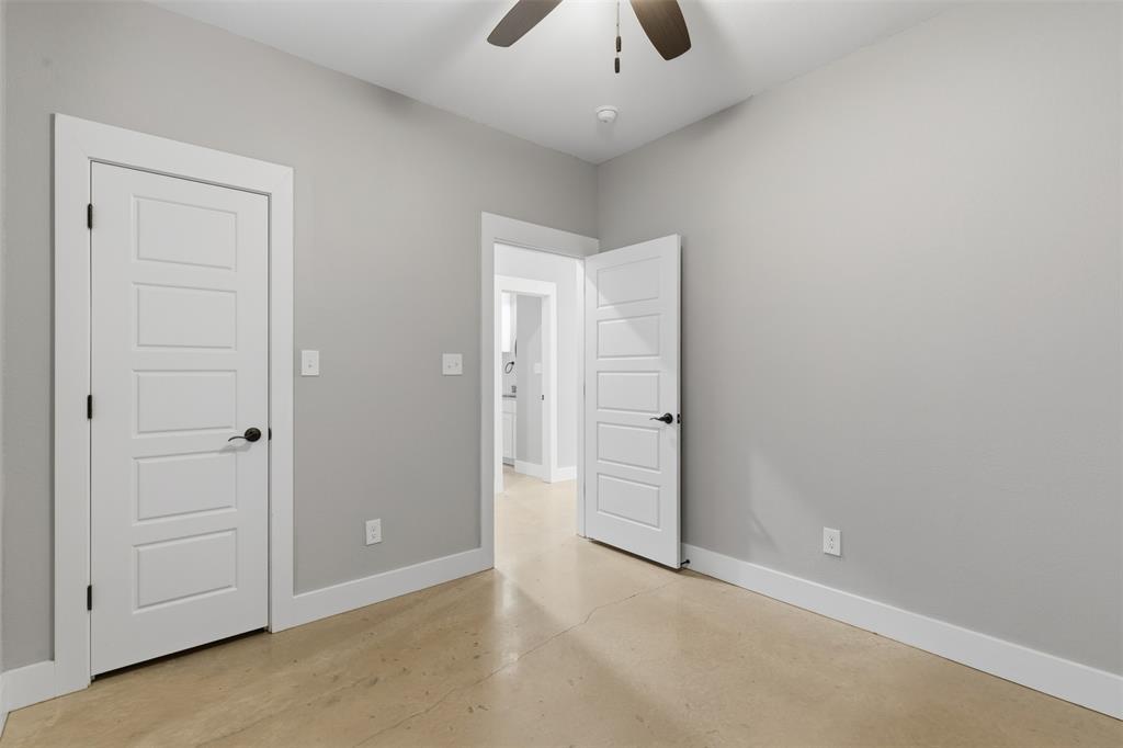 116 Harrison Street Denison, TX 75021 - Photo 13 of 25 Unfurnished bedroom with concrete floors and a ceiling fan