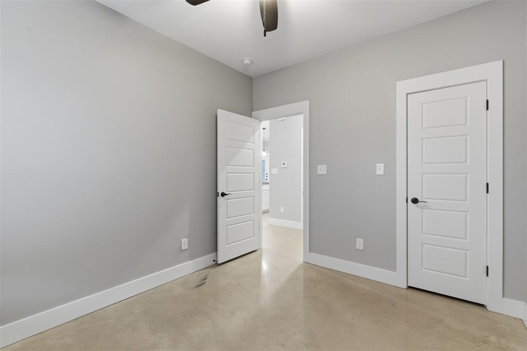 116 Harrison Street Denison, TX 75021 - Photo 14 of 25 Unfurnished bedroom with finished concrete floors and a ceiling fan