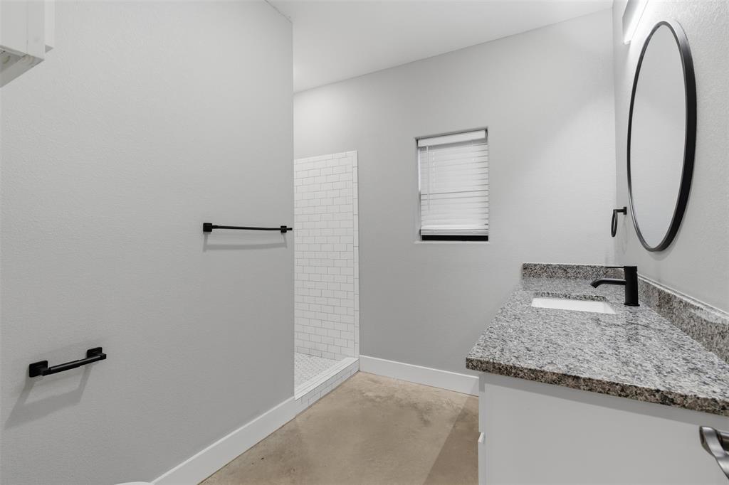 116 Harrison Street Denison, TX 75021 - Photo 22 of 25 Full bath featuring vanity, a tile shower, and concrete floors